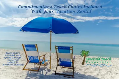 two chairs and an umbrella on the beach at Edgewater W102 'Tides Edge' in Panama City Beach
