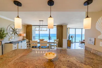 a kitchen and living room with a view of the ocean at Edgewater 2-1106 'Hidden Pearl' in Panama City Beach