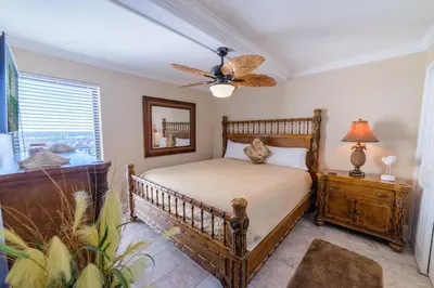 a bedroom with a bed and a ceiling fan at Edgewater 2-1106 'Hidden Pearl' in Panama City Beach