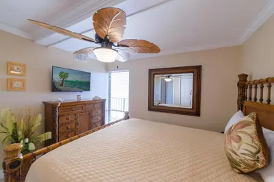 a bedroom with a bed and a ceiling fan at Edgewater 2-1106 'Hidden Pearl' in Panama City Beach