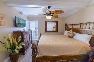 a bedroom with a bed and a ceiling fan at Edgewater 2-1106 'Hidden Pearl' in Panama City Beach