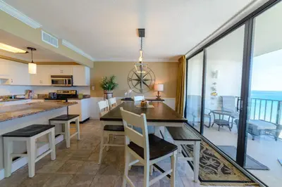 a kitchen and dining room with a table and chairs at Edgewater 2-1106 'Hidden Pearl' in Panama City Beach