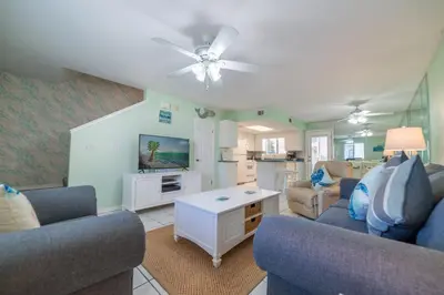 a living room with two couches and a tv at Gulf Highlands-Sunset On The Gulf in Panama City Beach