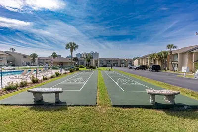 a tennis court with two benches on a street at Gulf Highlands-Sunset On The Gulf in Panama City Beach
