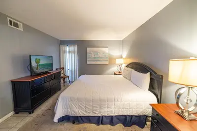 a bedroom with a bed and a television in it at Edgewater 2-1107 'Making Memories' in Panama City Beach