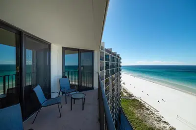 a balcony with chairs and a view of the beach at Edgewater 2-1107 'Making Memories' in Panama City Beach
