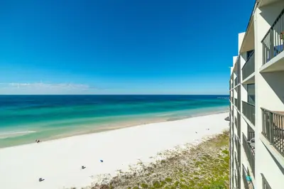 a view of the beach from the balcony of a building at Edgewater 2-1107 'Making Memories' in Panama City Beach