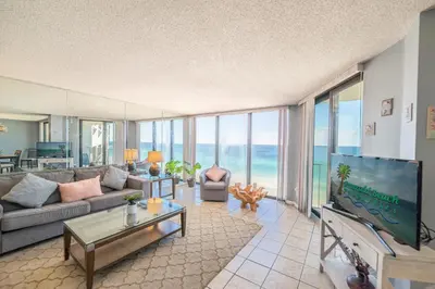 a living room with a couch and a tv at Edgewater 2-1107 'Making Memories' in Panama City Beach