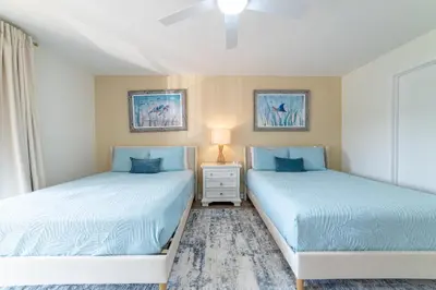 two beds sitting next to each other in a bedroom at Edgewater Villa 1105 'Villa Ardea' in Panama City Beach