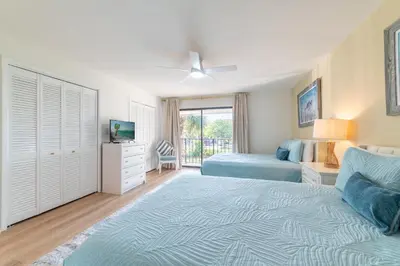 a bedroom with two beds and a window at Edgewater Villa 1105 'Villa Ardea' in Panama City Beach