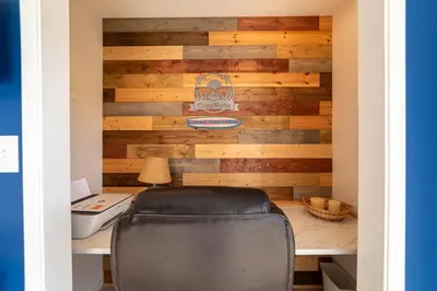 a desk with a chair in front of a wooden wall at Edgewater Villa 1101 'Sunset Paradise At Edgewater' in Panama City Beach