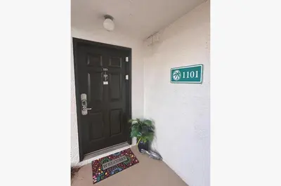 a door to a house with a plant next to it at Edgewater Villa 1101 'Sunset Paradise At Edgewater' in Panama City Beach