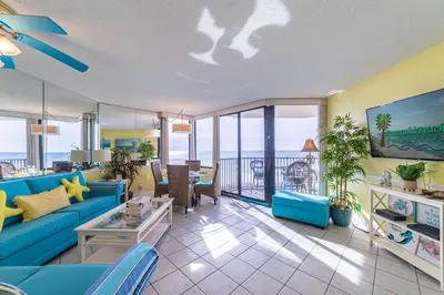 a living room with a blue couch at Sunbird 0703E 'Beachhead Paradise' in Panama City Beach