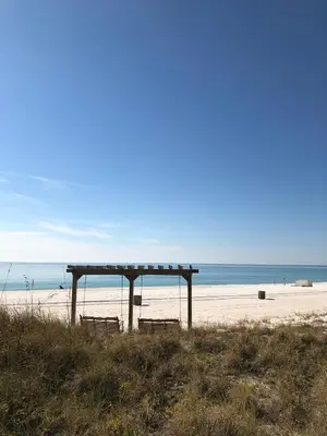 two benches on a beach with the ocean in the background at Sunbird 0703E 'Beachhead Paradise' in Panama City Beach