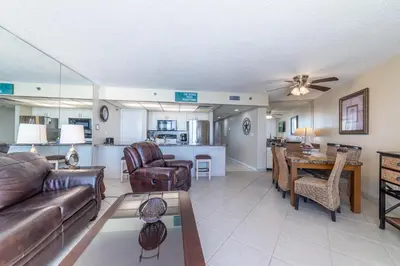 a living room with a couch and a table at Edgewater 3-1010 'The Salty Coconut' in Panama City Beach