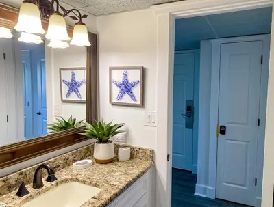 a bathroom with a sink and a mirror at Edgewater Villa 2901 'Tipsy Turtle' in Panama City Beach