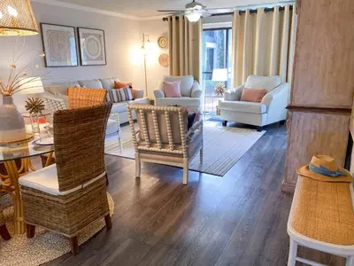 a living room with a couch and chairs and a table at Edgewater Villa 2901 'Tipsy Turtle' in Panama City Beach
