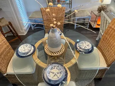 a glass table with chairs and a vase on it at Edgewater Villa 2901 'Tipsy Turtle' in Panama City Beach