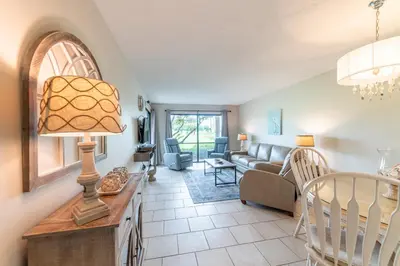 a living room with a couch and a table with a lamp at Edgewater Villa 2006 'Sandy Shores Hideaway' in Panama City Beach