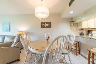 a kitchen and dining room with a table and chairs at Edgewater Villa 2006 'Sandy Shores Hideaway' in Panama City Beach