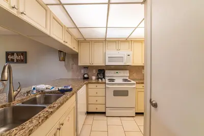 a kitchen with white appliances and a sink at Edgewater Villa 2006 'Sandy Shores Hideaway' in Panama City Beach