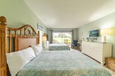 a bedroom with two beds and a large window at Edgewater Villa 2006 'Sandy Shores Hideaway' in Panama City Beach