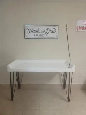a white table with a sign on a wall at Top Of The Gulf 312 'The Tip-Sea Turtle' in Panama City Beach