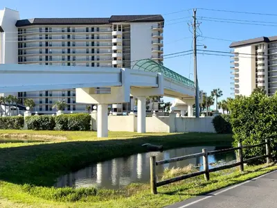 a bridge over a river in front of a building at Edgewater Villa 2809 'Shore 'Nuff' in Panama City Beach