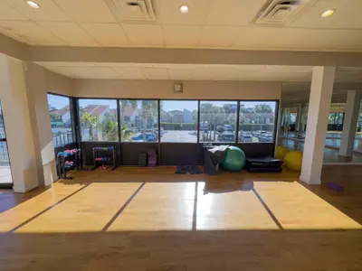 a large room with a gym with large windows at Edgewater Villa 2809 'Shore 'Nuff' in Panama City Beach