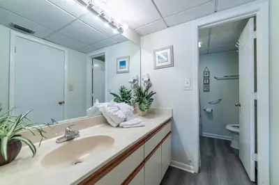 a bathroom with a sink and a mirror at Edgewater Villa 0402 'Serenity Now' in Panama City Beach
