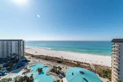 a view of the beach from the balcony of a resort at Edgewater 1-1212 'Combee's Penthouse HideAway' in Panama City Beach