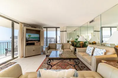 a living room with couches and a tv at Edgewater 1-1212 'Combee's Penthouse HideAway' in Panama City Beach