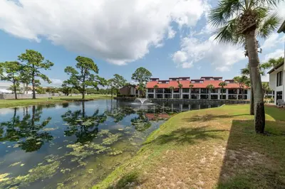 a view of the resort from across the pond at Edgewater Villa 0903 'Heron Landing' in Panama City Beach