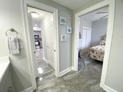 a hallway with a door leading to a bedroom at Boardwalk 2201 'Sea Serenity Penthouse' in Panama City Beach