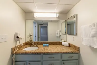 a bathroom with a sink and a mirror at Edgewater Villa 0103 'The Lily Pad' in Panama City Beach