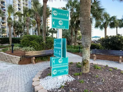 a pole with green street signs in a park at Edgewater Villa 0103 'The Lily Pad' in Panama City Beach