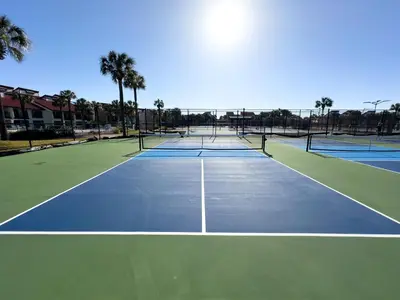 a tennis court with four tennis courts at Edgewater Villa 0103 'The Lily Pad' in Panama City Beach