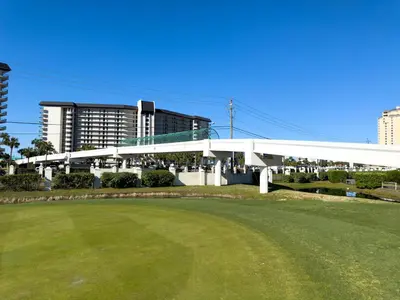 a white pavilion with a green field in front of a building at Edgewater Villa 0103 'The Lily Pad' in Panama City Beach