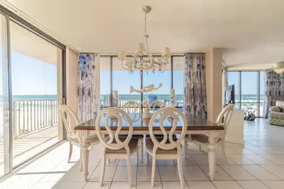 a dining room with a table and chairs at Edgewater L200 'Wish Upon A Starfish' in Panama City Beach
