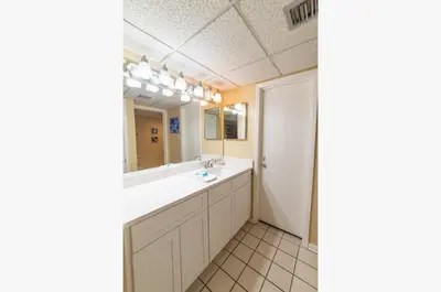 a bathroom with a sink and a mirror at Edgewater L200 'Wish Upon A Starfish' in Panama City Beach