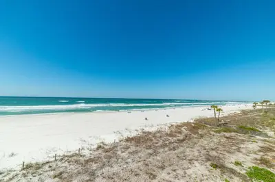 a view of a beach with people in the ocean at Edgewater L200 'Wish Upon A Starfish' in Panama City Beach