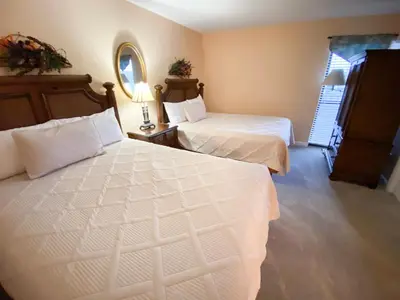 a bedroom with two beds and a window at Edgewater 1-0110 'Best Ocean View' in Panama City Beach