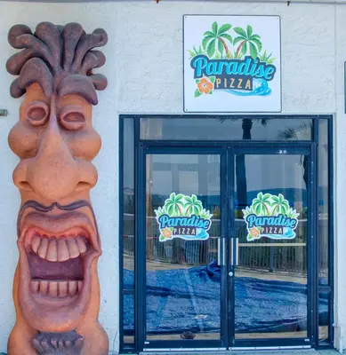 a front door of a restaurant with a statue of a face at Edgewater 1-0110 'Best Ocean View' in Panama City Beach