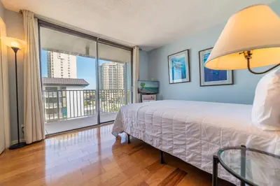 a bedroom with a bed and a large window at Edgewater L608 'Turquoise Turtle' in Panama City Beach