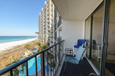 a balcony with chairs and a view of the beach at Edgewater 2-0405 'Make Some Waves' in Panama City Beach