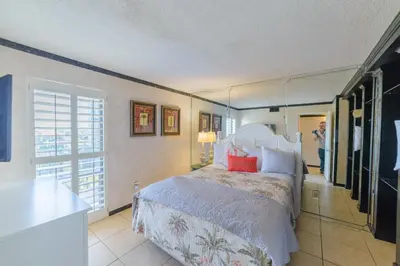 a bedroom with a bed and a large mirror at Edgewater 2-0405 'Make Some Waves' in Panama City Beach