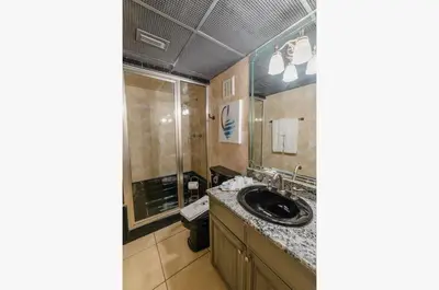 a bathroom with a sink and a shower at Edgewater 2-0405 'Make Some Waves' in Panama City Beach