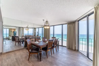 a dining room with a table and chairs and the ocean at Edgewater 3-0814 'Pelican Watch' in Panama City Beach