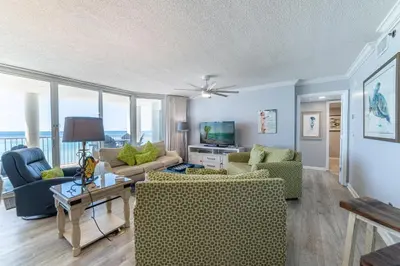 a living room with couches and chairs and windows at Long Beach 3-0501 ‘Edie's Escape' in Panama City Beach