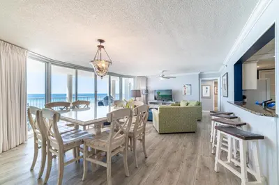 a dining room and living room with a table and chairs at Long Beach 3-0501 ‘Edie's Escape' in Panama City Beach